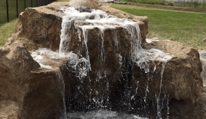 Small Backyard pond water feature by Above & Beyond Lawn & Landscaping