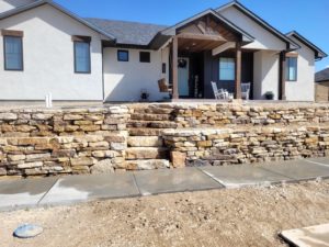 Two block retaining wall for residential home landscaping | Above & Beyond Lawn & Landscaping